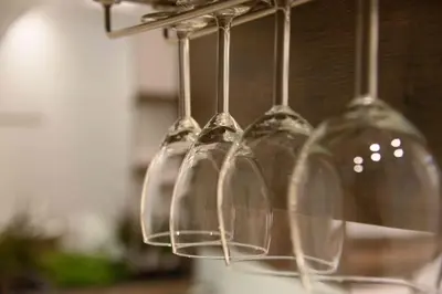 a group of wine glasses hanging from a rack at Electra & Myrto Apartments in Athens