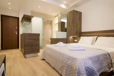 a bedroom with a bed with towels on it at Electra & Myrto Apartments in Athens
