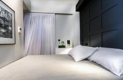 a bedroom with a large bed with a black headboard at Comfort studios in Kolonaki in Athens