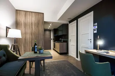a living room with a table and a kitchen at Comfort studios in Kolonaki in Athens