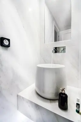 a white bathroom with a sink and a mirror at Comfort studios in Kolonaki in Athens