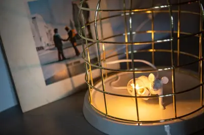 a candle with a toy mouse in a cage at The Foundry Suites in Athens