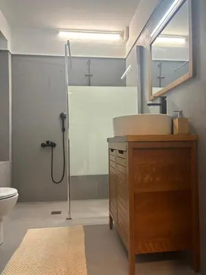 a bathroom with a sink and a shower in it at Athens Countryside resort with pool in Pallíni