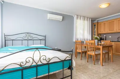 a bedroom with a bed and a table and chairs at Athens Countryside resort with pool in Pallíni