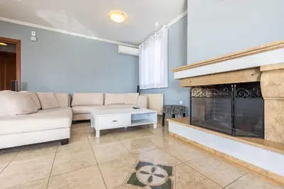a living room with a couch and a fireplace at Athens Countryside resort with pool in Pallíni