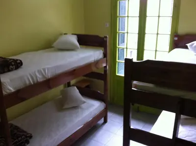 a room with two bunk beds and a chair at Zeus Hostel in Athens