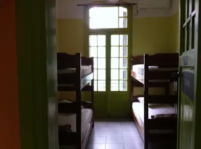 a room with bunk beds in a room with a window at Zeus Hostel in Athens