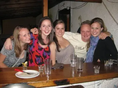 a group of people posing for a picture at a table at Zeus Hostel in Athens