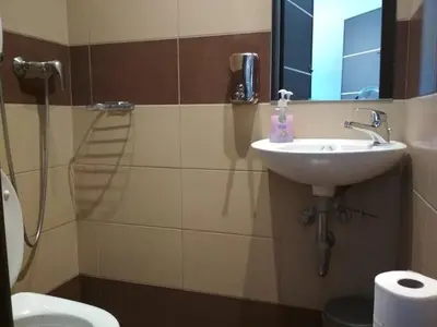 a bathroom with a sink and a mirror at Pella Inn Hostel in Athens