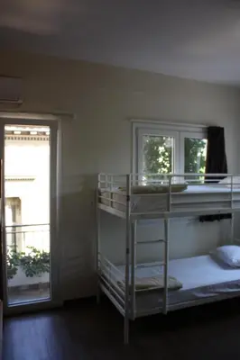 a room with two bunk beds and a window at Pella Inn Hostel in Athens