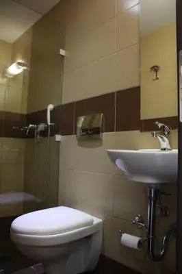 a bathroom with a toilet and a sink at Pella Inn Hostel in Athens
