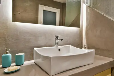 a bathroom with a white sink and a mirror at Athens Memory in Athens
