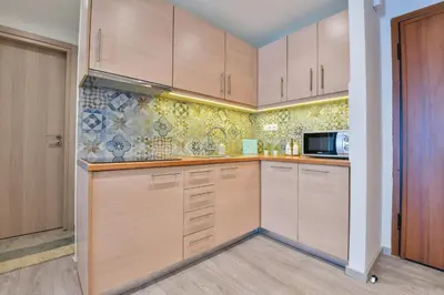 a kitchen with wooden cabinets and a microwave at Athens Memory in Athens