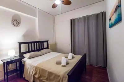 a bedroom with a bed with two towels on it at Stylish apt in Athens center in Athens