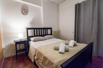 a bedroom with a large bed with two pillows on it at Stylish apt in Athens center in Athens