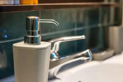 a bathroom sink with a faucet and a mirror at Stylish apt in Athens center in Athens