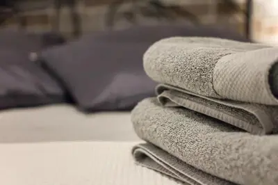 a pile of towels sitting on top of a bed at Stylish apt in Athens center in Athens
