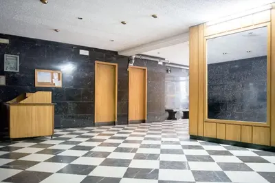 an empty room with a checkered floor and doors at Stylish apt in Athens center in Athens