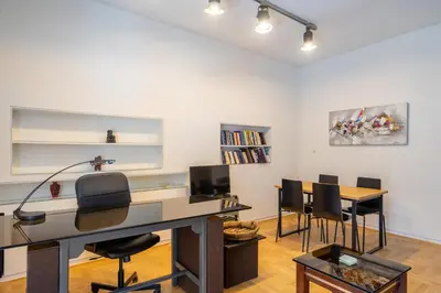 an office with a desk and chairs in a room at Charming and renovated flat in the heart of Athens in Athens