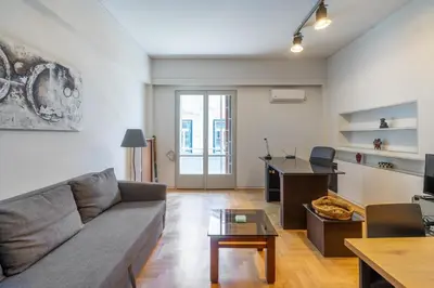 a living room with a couch and a table at Charming and renovated flat in the heart of Athens in Athens