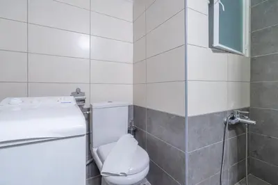 a white bathroom with a toilet and a window at Charming and renovated flat in the heart of Athens in Athens
