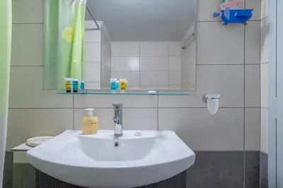 a bathroom with a white sink and a mirror at Charming and renovated flat in the heart of Athens in Athens