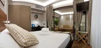 a bedroom with a white bed and a living room at Marble House in Athens