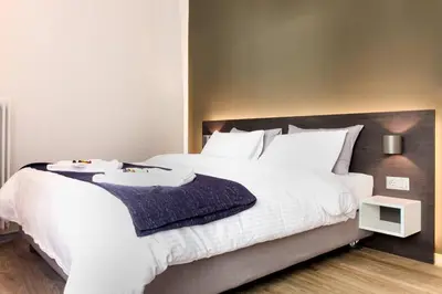 a bedroom with a large white bed with white pillows at TONI'S 2BD Gem House near Plaka and Syntagma in Athens
