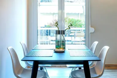 a blue table with chairs and a vase on it at TONI'S 2BD Gem House near Plaka and Syntagma in Athens