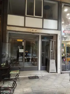 a store front with a sign on the front of it at TONI'S 2BD Gem House near Plaka and Syntagma in Athens