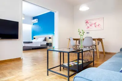 a living room with a couch and a table at TONI'S 2BD Home in Centre, 15 sec to Metro in Athens