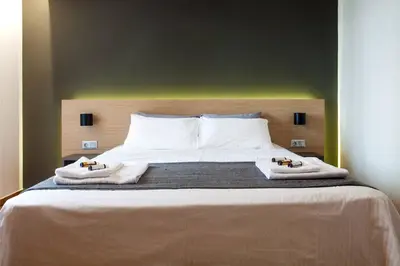 a bedroom with a large bed with towels on it at TONI'S 2BD Home in Centre, 15 sec to Metro in Athens
