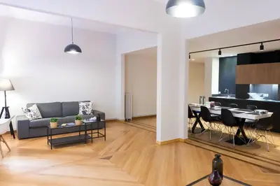 a living room with a couch and a table at TONI'S 4BD near Classy KOLONAKI, locals enjoy it in Athens