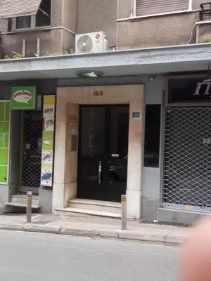a building with the door open on a city street at TONI'S 4BD near Classy KOLONAKI, locals enjoy it in Athens