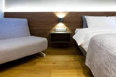 a bedroom with two beds and a couch and a lamp at TONI'S Charming Apartment 2BD, close Thisseo Metro in Athens