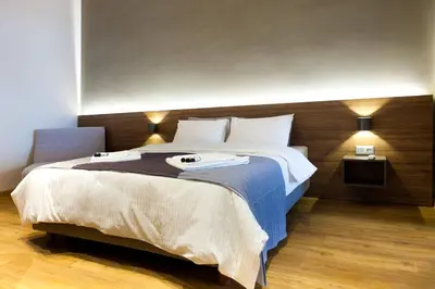 a bedroom with a large bed with two towels on it at TONI'S Charming Apartment 2BD, close Thisseo Metro in Athens