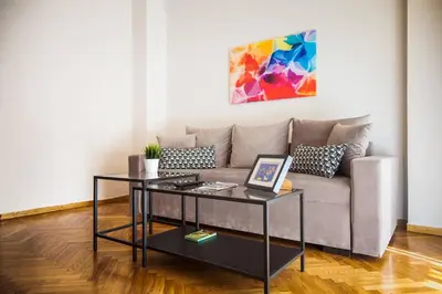 a living room with a couch and a table at TONI'S Classy Home in Kolonaki, local's Gem in Athens