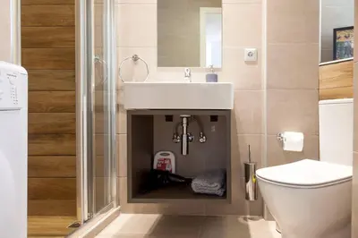 a bathroom with a sink and a toilet at TONI'S Classy Home in Kolonaki, local's Gem in Athens