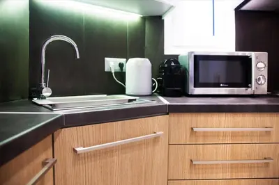 a kitchen with a sink and a microwave at TONI'S Classy Home in Kolonaki, local's Gem in Athens