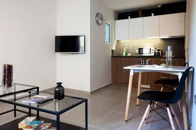 a living room with a table and a kitchen at TONI'S Charming Apartment in the Thisseo station in Athens