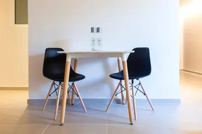 a table with two black chairs and a white table at TONI'S Charming Apartment in the Thisseo station in Athens
