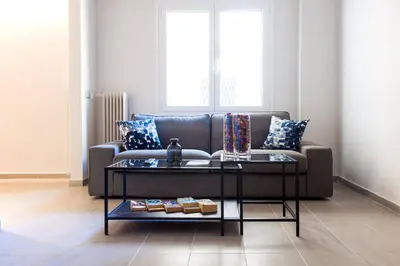 a living room with a couch and a table at TONI'S Charming Apartment in the Thisseo station in Athens