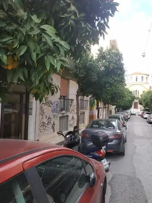 a street with cars parked on the side of the road at TONI'S Charming Apartment in the Thisseo station in Athens