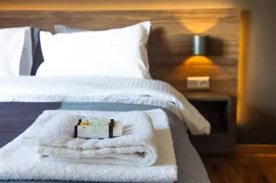 a hotel room with a bed with towels on it at TONI'S Charming Apartment in the Thisseo station in Athens