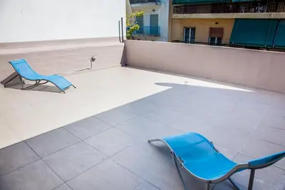 two blue chairs sitting on top of a roof at TONI'S Comfy 3BD home with patio, close to Metro in Athens