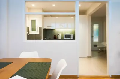 a kitchen and dining room with a table and chairs at TONI'S Comfy home near Acropolis with Small Garden in Athens