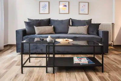 a living room with a blue couch and a table at TONI'S Cosy Apartment next to Syntagma Square in Athens