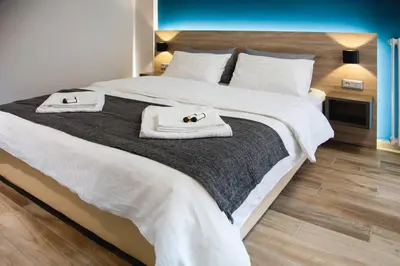 a bedroom with a large bed with towels on it at TONI'S Cosy Apartment next to Syntagma Square in Athens