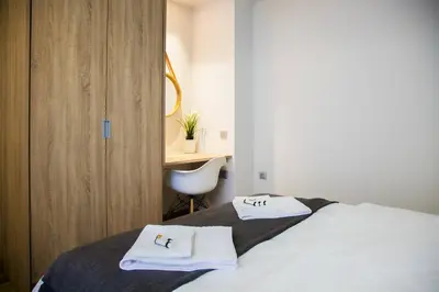 a bedroom with a bed with white towels on it at TONI'S Cosy Apartment next to Syntagma Square in Athens