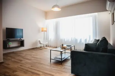 a living room with a couch and a table at TONI'S Cosy Apartment next to Syntagma Square in Athens